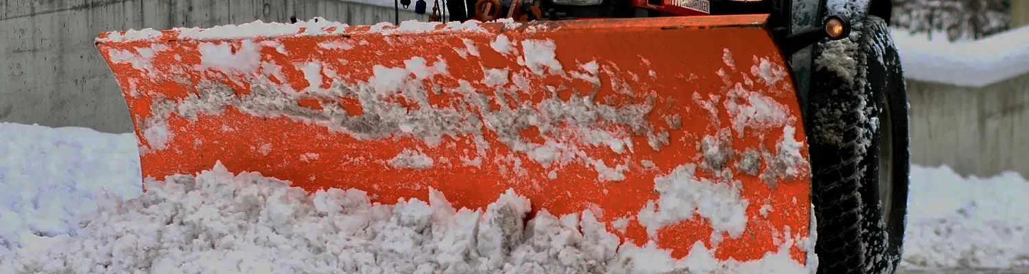 Snow plow removing snow
